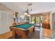 Bright game room with a billiard table, wood floors, and access to the outdoor patio at 14344 83Rd Pl, Seminole, FL 33776