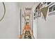 Hallway decorated with floral patterned rug, and Gathering photos on the wall at 14344 83Rd Pl, Seminole, FL 33776