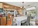 Open kitchen and dining area with hardwood floors, wood ceiling, and black countertops at 14344 83Rd Pl, Seminole, FL 33776