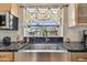 Kitchen sink with view of the backyard through window and designer curtains at 14344 83Rd Pl, Seminole, FL 33776