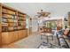Cozy living room with built-in shelves, plush rug, fireplace, and a pool table in background at 14344 83Rd Pl, Seminole, FL 33776