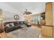 Cozy living room featuring a large leather sectional sofa, plush carpet, and entertainment center at 14344 83Rd Pl, Seminole, FL 33776