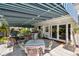 A tiled patio features a covered dining area and a full outdoor kitchen at 14344 83Rd Pl, Seminole, FL 33776