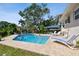 Beautiful pool area with brick pavers, lounge chairs, and a well-maintained yard at 14344 83Rd Pl, Seminole, FL 33776