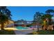 Evening shot of the backyard pool, patio, and beautifully landscaped yard at 14344 83Rd Pl, Seminole, FL 33776
