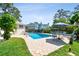Backyard pool with brick surround, patio furniture and lush landscaping create a private oasis at 14344 83Rd Pl, Seminole, FL 33776