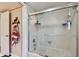 Bathroom showcasing a clean and modern shower with glass doors and tiled walls at 14344 83Rd Pl, Seminole, FL 33776