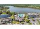 Aerial view showcasing a community pool, clubhouse, and lakefront property with lush landscaping at 14609 Canopy Dr, Tampa, FL 33626