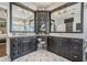 Stunning bathroom featuring custom cabinets, marble countertops, and decorative tile flooring at 14609 Canopy Dr, Tampa, FL 33626