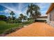View from back patio reveals lush landscaping and tranquil lake views at 1522 Riverdale Dr, Oldsmar, FL 34677