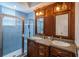 Bathroom featuring double sinks, a glass enclosed shower, and modern fixtures at 1522 Riverdale Dr, Oldsmar, FL 34677