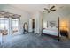 A primary bedroom boasts a four poster bed, neutral walls, and access to lanai at 1522 Riverdale Dr, Oldsmar, FL 34677