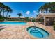 Community pool and spa area with lounge chairs and shaded seating at 1522 Riverdale Dr, Oldsmar, FL 34677