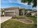 Charming single-story home showcasing manicured landscaping and a two-car garage at 1522 Riverdale Dr, Oldsmar, FL 34677