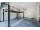 Spacious garage with a car lift, epoxy floors, and ample storage space at 1522 Riverdale Dr, Oldsmar, FL 34677
