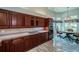 A spacious kitchen with wood cabinetry, stainless steel appliances, and adjacent breakfast nook at 1522 Riverdale Dr, Oldsmar, FL 34677
