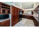 Expansive kitchen featuring custom wood cabinets, modern appliances, and a mirrored backsplash at 1522 Riverdale Dr, Oldsmar, FL 34677