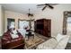 Bright living area with hardwood floors, comfortable seating, and a large entertainment center at 1522 Riverdale Dr, Oldsmar, FL 34677