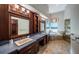 Luxurious main bathroom boasts dual sinks, dark wood cabinetry, and a soaking tub at 1522 Riverdale Dr, Oldsmar, FL 34677