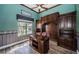 Home office with custom built-in shelves, cabinets, and a sleek wooden desk at 1522 Riverdale Dr, Oldsmar, FL 34677