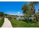 Scenic view of the pond from the walkway, featuring a fountain at 1522 Riverdale Dr, Oldsmar, FL 34677