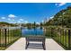 Enjoy serene pond views from this seating area with bench and railing at 1522 Riverdale Dr, Oldsmar, FL 34677