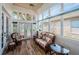 Inviting sunroom with large windows, comfortable seating, and views of the lake at 1522 Riverdale Dr, Oldsmar, FL 34677