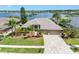 Aerial view of a beautiful home on a large lot with a lake view, lush landscaping, and a paver driveway at 16529 Ivy Lake Dr, Odessa, FL 33556