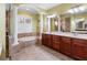Spacious primary bathroom boasts double vanities, soaking tub, walk-in shower, and decorative columns at 16529 Ivy Lake Dr, Odessa, FL 33556