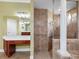 Elegant bathroom features a walk-in shower, vanity, and classic design elements at 16529 Ivy Lake Dr, Odessa, FL 33556