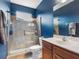 Bathroom featuring a tiled walk-in shower, commode, and a vanity at 16529 Ivy Lake Dr, Odessa, FL 33556