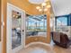 A dining area offering views of the pool, outdoor grill, and lake beyond at 16529 Ivy Lake Dr, Odessa, FL 33556