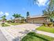 A spacious driveway leads to a home with a well-manicured lawn and beautiful landscaping at 16529 Ivy Lake Dr, Odessa, FL 33556