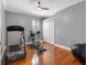 Bright exercise room featuring gleaming hardwood floors, neutral walls, and ample space for fitness equipment at 16529 Ivy Lake Dr, Odessa, FL 33556