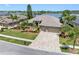 A beautiful home, complete with lush landscaping, paver driveway, and attached three-car garage at 16529 Ivy Lake Dr, Odessa, FL 33556