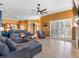 Spacious living room with tile floors, ceiling fan, and sliding glass doors that lead to the outdoor area at 16529 Ivy Lake Dr, Odessa, FL 33556