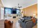 Cozy living room with fireplace, built-in shelving, large windows, and comfortable seating area at 16529 Ivy Lake Dr, Odessa, FL 33556