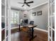 Home office with hardwood floors, neutral gray walls, natural light, and contemporary decor at 16529 Ivy Lake Dr, Odessa, FL 33556