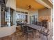 Outdoor dining on the patio, complete with an outdoor kitchen and serene views of the pool and lake at 16529 Ivy Lake Dr, Odessa, FL 33556