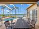 Spacious screened patio with comfortable seating, overlooking the pool, spa, and serene lake at 16529 Ivy Lake Dr, Odessa, FL 33556