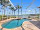 Stunning screened-in pool and spa overlooking a serene lake, creating a relaxing outdoor living space at 16529 Ivy Lake Dr, Odessa, FL 33556