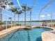 Beautiful screened pool area with lush landscaping, overlooking lake views providing relaxation and privacy at 16529 Ivy Lake Dr, Odessa, FL 33556