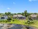 A beautiful backyard view features a screened pool, well-manicured lawn, mature trees, and a peaceful pond at 16529 Ivy Lake Dr, Odessa, FL 33556