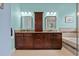 Primary bathroom with double vanity, granite countertops, and a separate soaking tub at 19026 Dove Creek Dr, Tampa, FL 33647