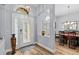 Elegant foyer with a decorative front door, wood floors, and views into the dining room at 19026 Dove Creek Dr, Tampa, FL 33647