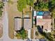 Aerial shot of houses with a pool, well-kept lawns, mature landscaping, and a shed at 2410 26Th S St, St Petersburg, FL 33712