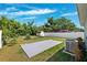 Backyard features a well-maintained lawn, shed, white fence, and a concrete patio, ideal for outdoor living at 2410 26Th S St, St Petersburg, FL 33712