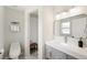 Clean bathroom features a modern vanity, toilet and walk-in shower with bench at 2410 26Th S St, St Petersburg, FL 33712