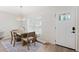 The dining room features a wooden table, modern lighting, and a window that provides natural light at 2410 26Th S St, St Petersburg, FL 33712