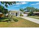 Charming single-story home features a well-manicured lawn and a concrete driveway at 2410 26Th S St, St Petersburg, FL 33712